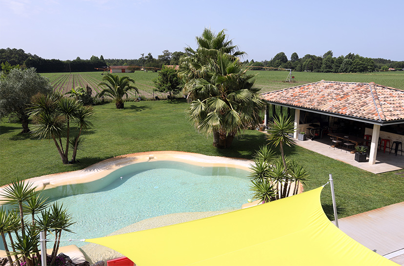 Vue sur jardin et piscine d'une maison moderne dans les Landes